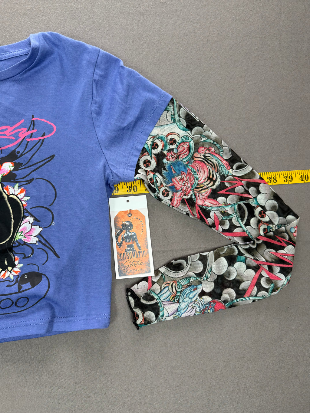 Ed Hardy – Women’s Layered Tattoo-Sleeve Graphic T-Shirt – Style #: EHW1415-6 – Size: Medium – Color: Purple / Blue / Multicolor