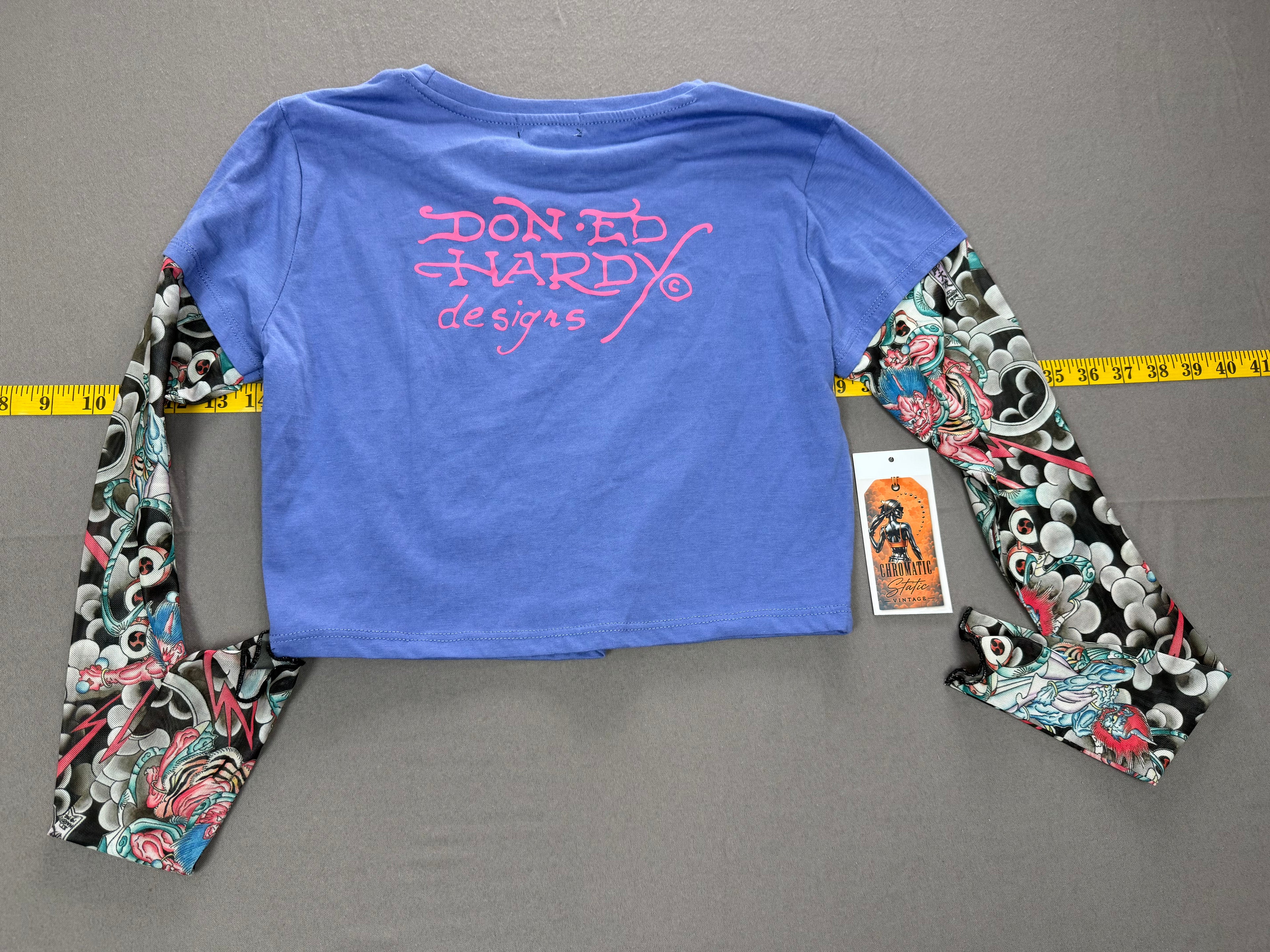 Ed Hardy – Women’s Layered Tattoo-Sleeve Graphic T-Shirt – Style #: EHW1415-6 – Size: Medium – Color: Purple / Blue / Multicolor